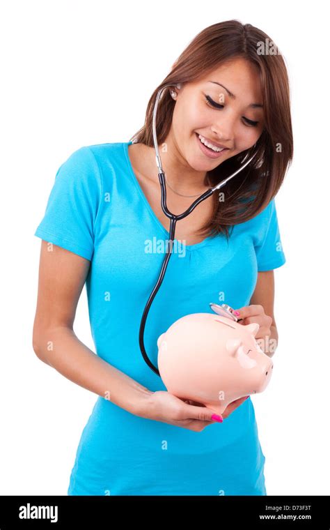 Young Happy Beautiful Asian Woman Using Stethoscope On Her Piggy Bank