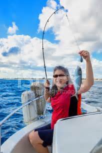 Woman Catching A Fish Stock Photos