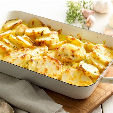 Place potatoes, cut side up, in a lightly greased 13x9x2 baking pan. Cheesy Potato Bake Recipe | myfoodbook | The best potato bake