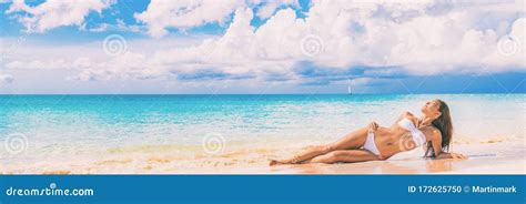 Beach Paradise Bikini Woman Lying Down On Sand Relaxing Sun Tanning In Tropical Caribbean Travel