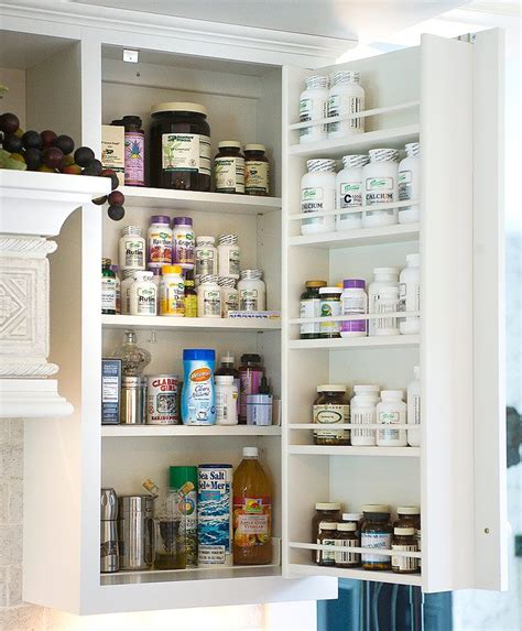 We could mention wooden hoods, furniture style islands, specialty cabinets, decorative accessories, carved moldings, curved moldings, iron, carved design such as enkeboll products, simple wooden or even hidden counter top supports, but that is only scratching the surface of what is possible with our amish craftsmen. Vitamin cabinet. custom kitchen design by Mullet Cabinet in Millersburg, Ohio | Custom kitchens ...