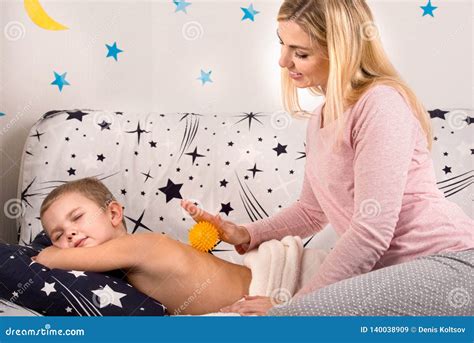 The Mother Makes The Massage Of The Back Of His Little Son Stock Image