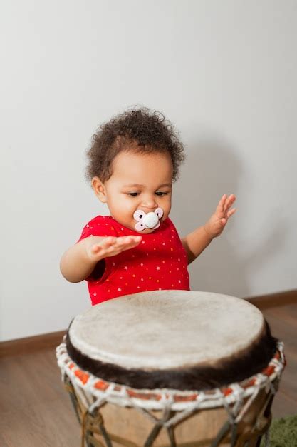 Premium Photo Beautiful Little African Kid Playing Drum