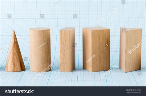 Wooden Geometric Shapes On Graph Paper Stock Photo
