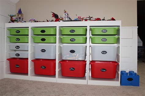 The Shelves Are Filled With Many Different Colored Bins And Toy Cars On