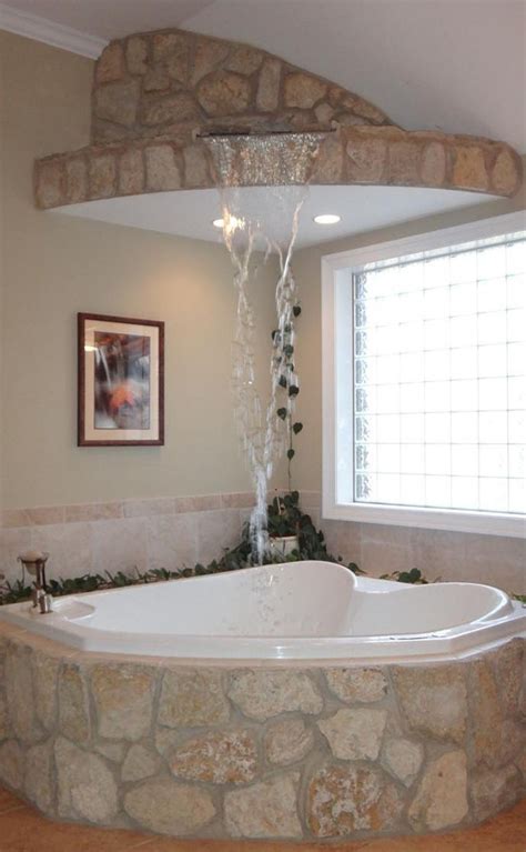 Trendy bathroom remodeling ideas that endure. A waterfall fills this corner jacuzzi tub in a master ...