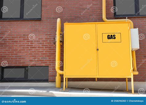 Gas Distribution System With Pipes Near Red Brick Wall Outdoors Stock