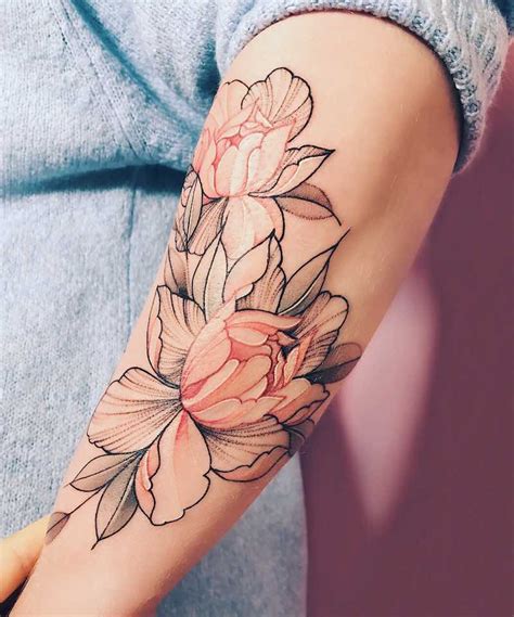 An interesting lotus flower tattoo etched sharply in black line and supported by a range of fill from negative space and black shading. 117 Of The Very Best Flower Tattoos - Tattoo Insider