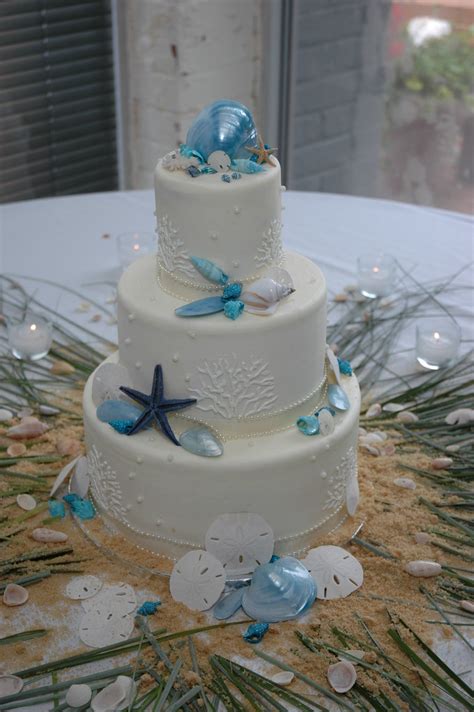 Our all inclusive beach wedding packages are designed for couples eloping in florida and where can you meet us? Beach Themed Wedding Cake | Wedding cake adorned with Blue ...