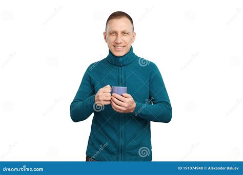 Smiling Average Age Man In Blue Sweater Isolated On White Background Holding A Blue Cup Of