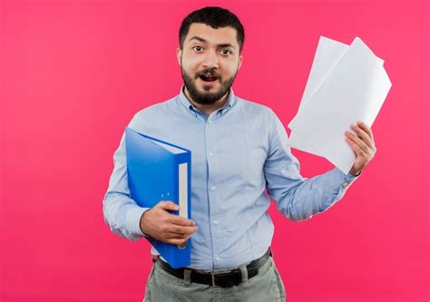 Free Photo Young Bearded Man In Blue Shirt Holding Folder And Blank