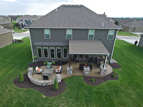 Backyard patio ideas with fire pit. #outdoorliving #stoneveneer #patio #stampedconcrete # ...