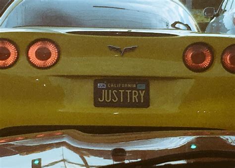 the back end of a yellow car with its lights on