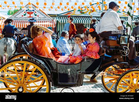 Spanish Families In Traditional Dress Travelling In A Horse Drawn