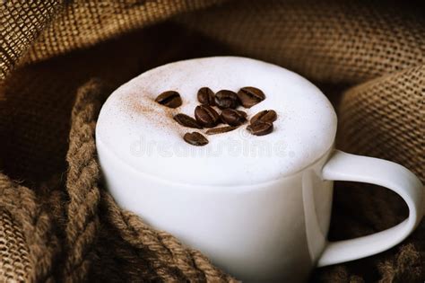 fresh cappuccino coffee cup with coffee beans on burlap sack stock image image of break close