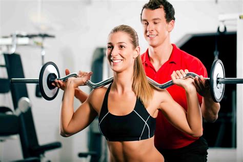 Woman With Personal Trainer In Gym LPB Fitness