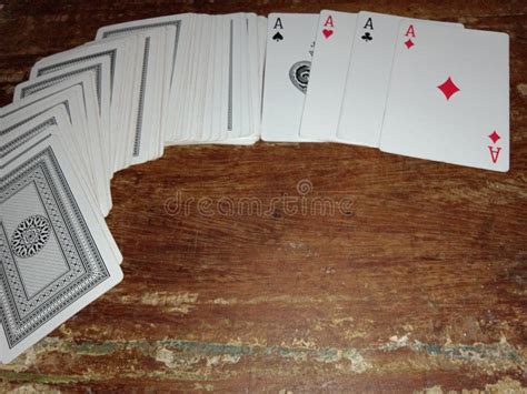 Full Deck Playing Cards With Four Aces Scattered Over Rustic Wooden