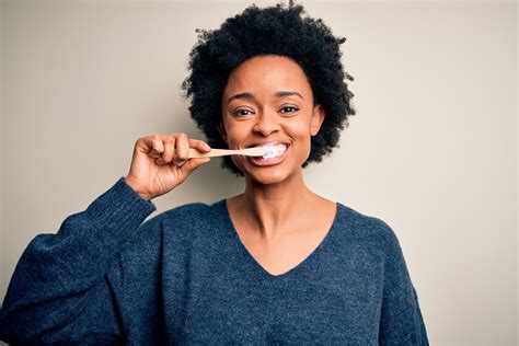African American Woman Brushing Her Teeth Using Tooth Brush And South