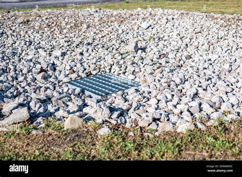 Grated Storm Drain Inlet Surrounded By Rock For Soil Erosion Control