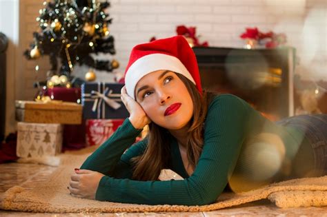 Premium Photo Pretty Woman Lying On The Rug In The Living Room Of Her House With Christmas