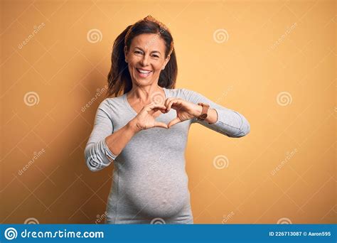 Middle Age Pregnant Woman Expecting Baby At Aged Pregnancy Smiling In