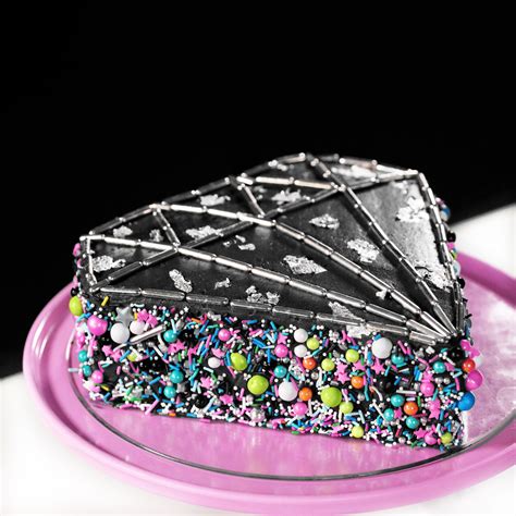A Piece Of Cake With Sprinkles On It Sitting On A Pink Plate