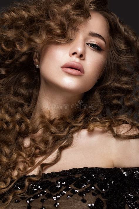Beautiful Brunette Girl With A Perfectly Curly Hair And Classic Make