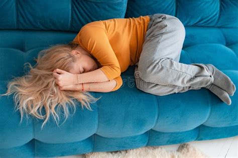 Depressed Mature Woman Lying Sofa With Her Arms Around Herself Covering Her Head With Hands