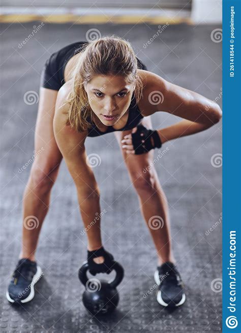 Strong Mindset Strong Body A Young Woman Working Out With Kettlebells