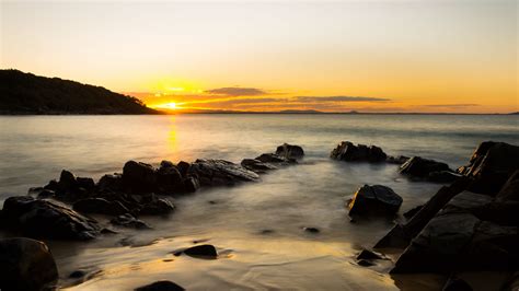 Download Wallpaper 3840x2160 Sea Sunset Stones Horizon Sky 4k Uhd