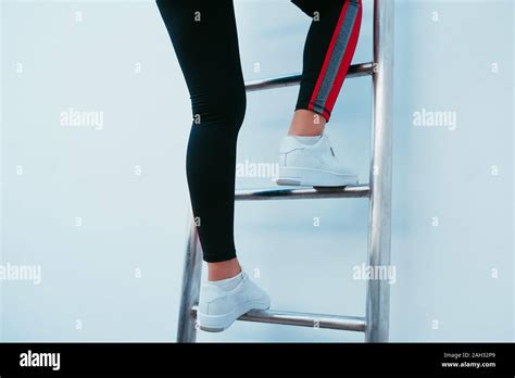 Sporty Woman Climbing The Ladder Stock Photo Alamy