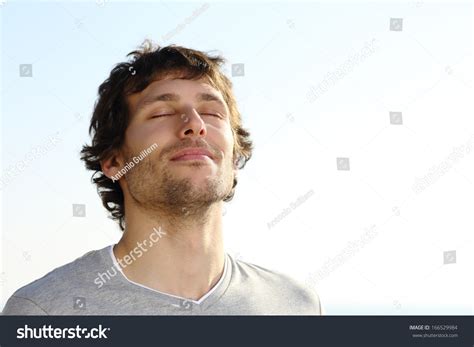 Attractive Man Breathing Outdoor With The Sky In The Background Stock