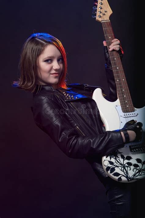 Young Attractive Rock Girl Playing The Electric Guitar Stock Photo