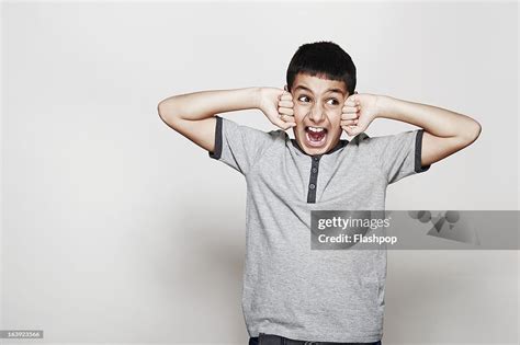 Portrait Of Boy Pulling Funny Faces Stock Foto Getty Images