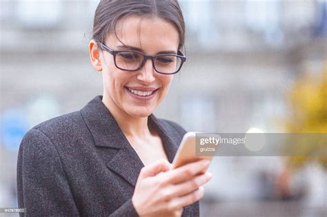 Young Woman Using Her Smart Phone On The City Street High Res Stock