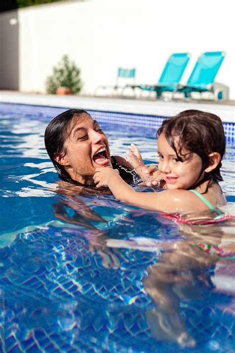 Playful Mother And Daughter In Swimming Pool Del Colaborador De Stocksy Ezequiel Giménez