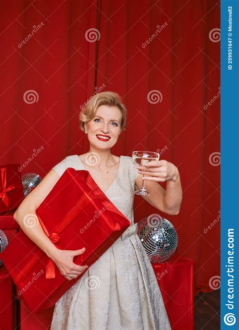 Mature Stylish Elegant Woman In Cocktail Dress With Glass Of Sparkling Wine With T Box In Her