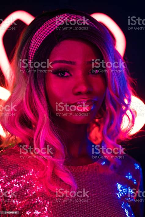beautiful african girl in sparkling dress with ombre hairstyle looking at camera close up
