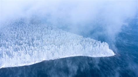 Panoramic Aerial View Of The Winter Snow Covered Forest Island And