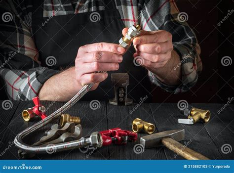 Plumber Connects Brass Fittings To Plumbing Hose Close Up Of Hand Of