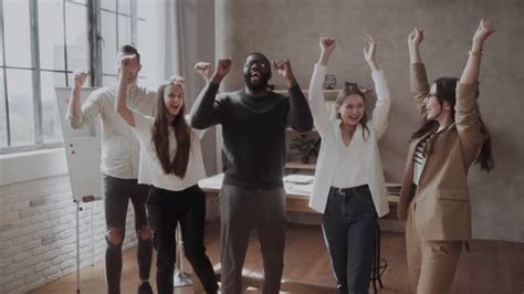 Excited Diverse Business Team In Casual Celebrate Hands Up Corporate
