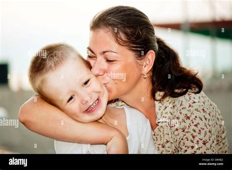 Mother Kissing Her Childs Cheek Stock Photo Alamy