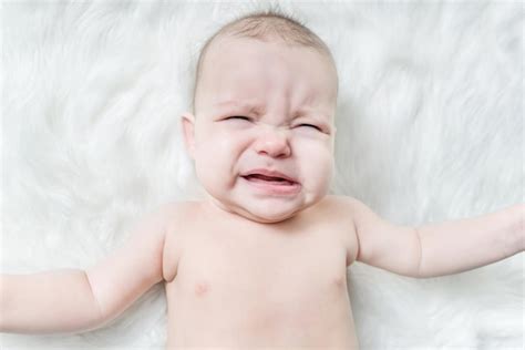 Premium Photo Cute Baby Crying On A White Fur