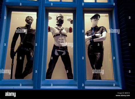 a shop window display in the red light district in amsterdam showing three male mannequins