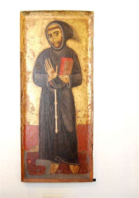 An Old Painting With A Nun Holding A Book In It S Right Hand On The Wall