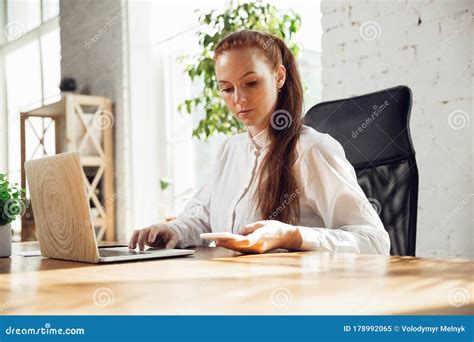 Caucasian Young Woman In Business Attire Working In Office Stock Image