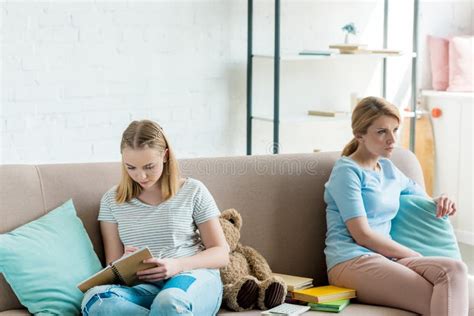 Mother And Daughter Sitting On Couch Stock Image Image Of Relationship Schoolgirl 127759257