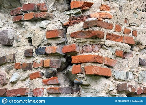 Old Crumbling Masonry Wall With Red Bricks And Stonesold Red Brick
