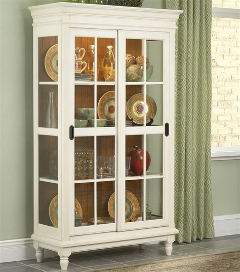 With framed glass doors covering the display area on top and wooden panel doors at the bottom for additional storage. Curio Cabinet with Crown Moulding, Turned Feet, and ...
