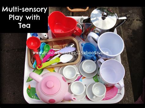 sun hats and wellie boots pouring and transferring play with tea
